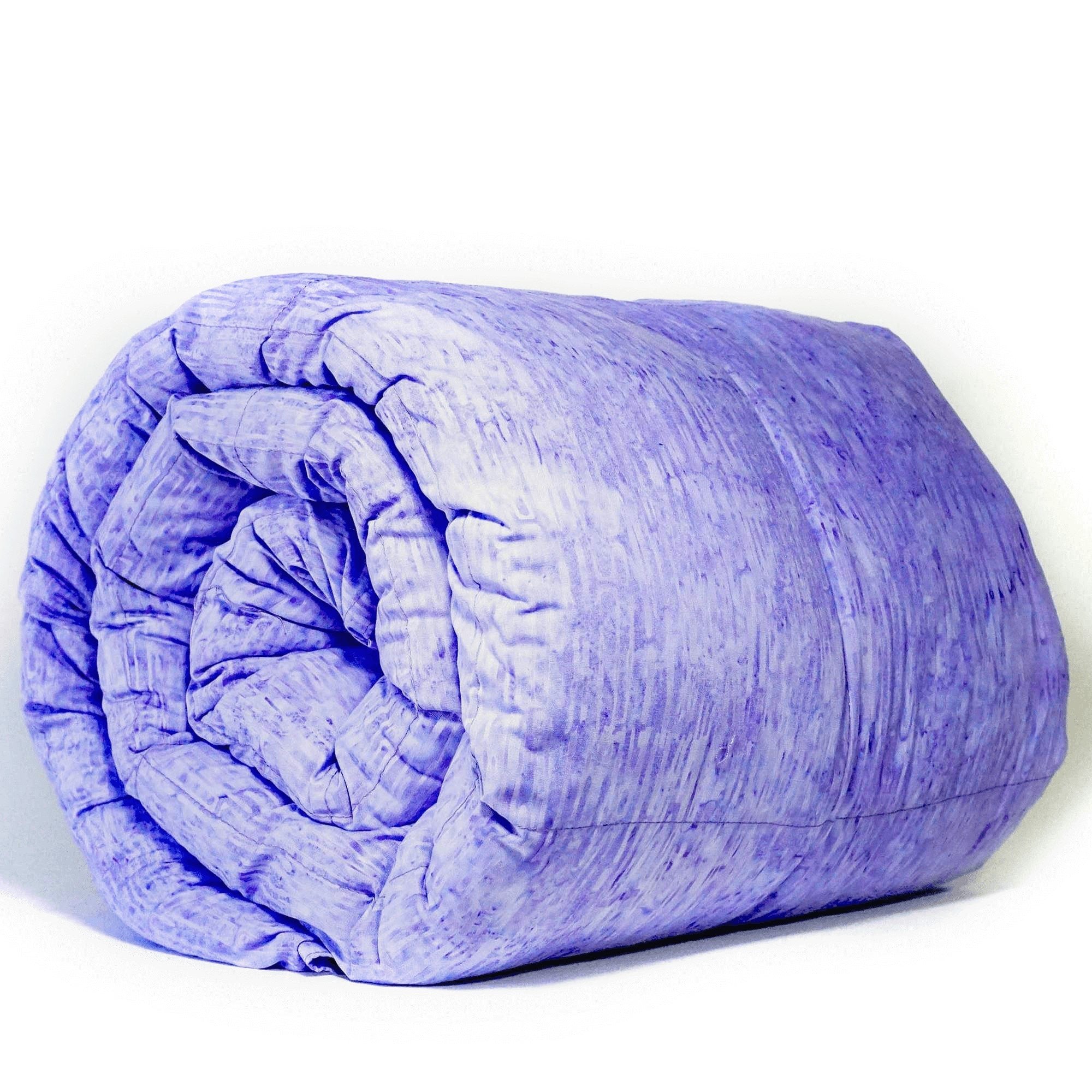 Woman snuggled under her Mosaic Weighted Blankets Indigo Purple Weighted Blanket on the couch